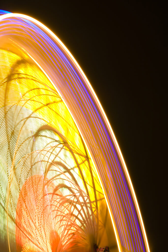 Scotland, Edinburgh, Christmas Fair. Ferris wheel located near the Scott Monument in East Princes Street Gardens.