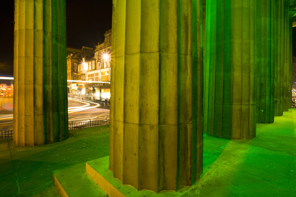 Scotland, Edinburgh, Royal Scottish Academy. Illuminated facade of the Royal Scottish Academy on the busy Princes Street.