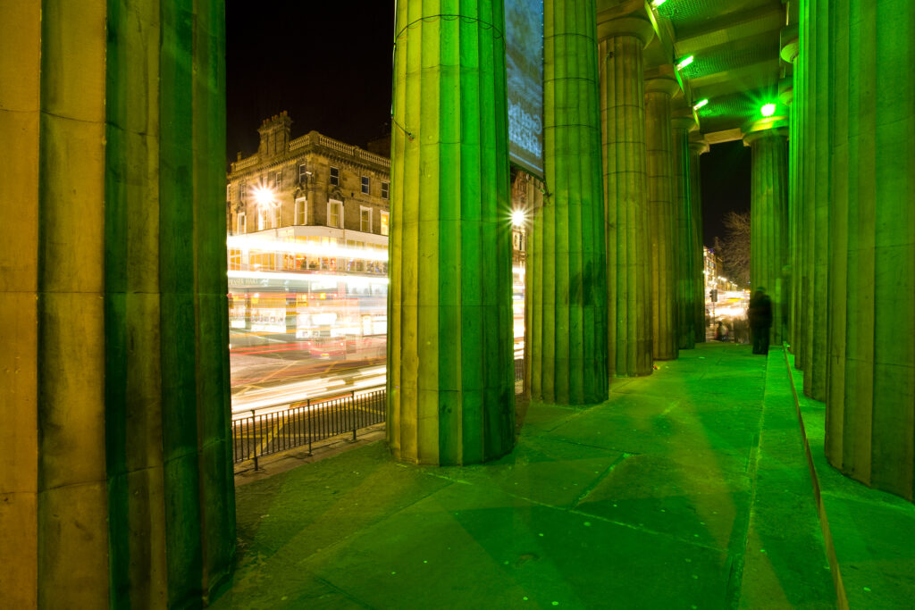 Scotland, Edinburgh, Royal Scottish Academy. Illuminated facade of the Royal Scottish Academy on the busy Princes Street.