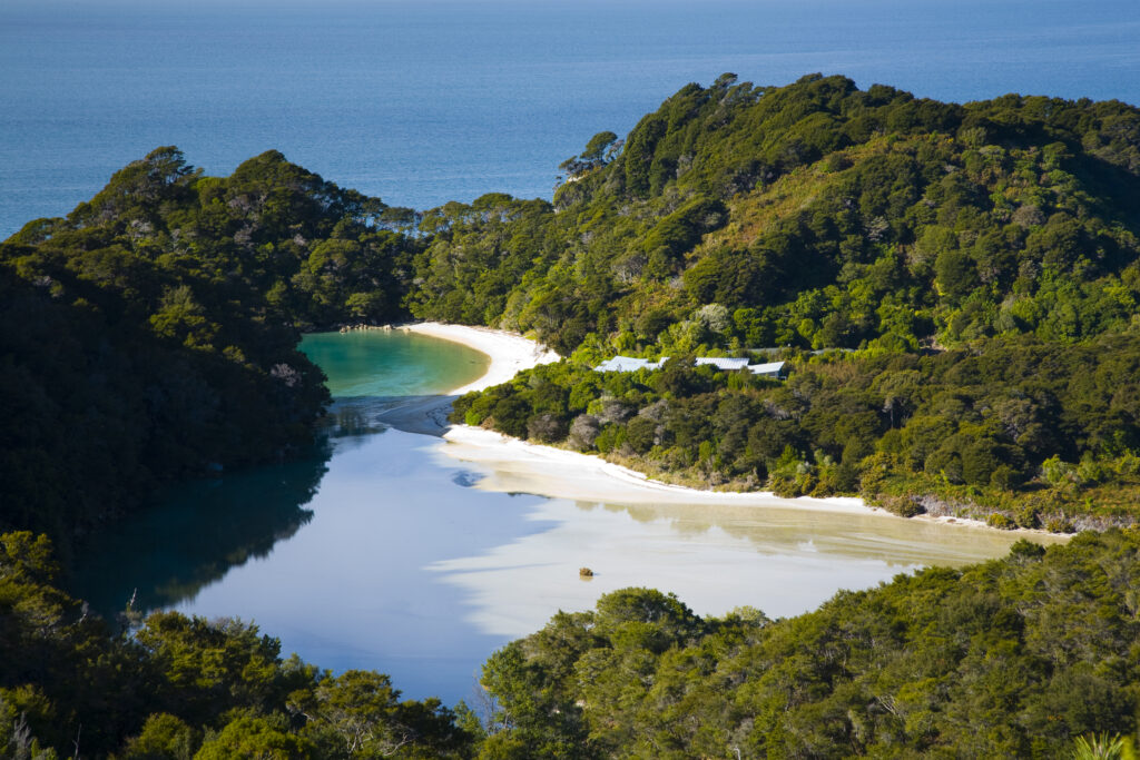 New Zealand, Nelson, Abel Tasman National Park. Frenchman's Bay / cove , a tidal lagoon viewed from above on a viewpoint along the Coastal Track.
