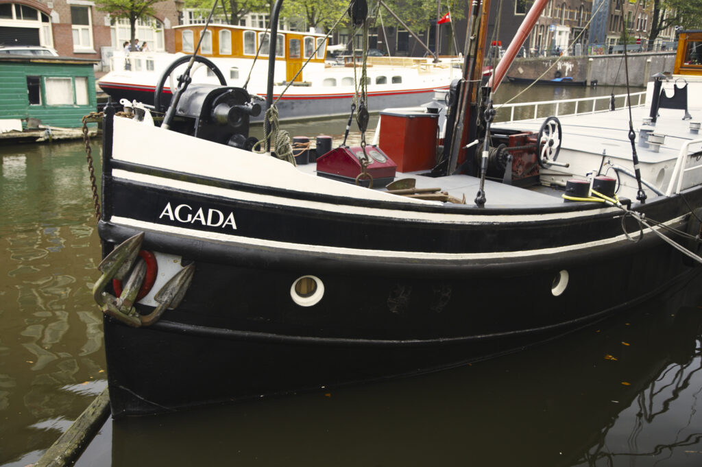 Netherlands, North Holland, Amsterdam. Boat moored on a canal in Amsterdam City.
