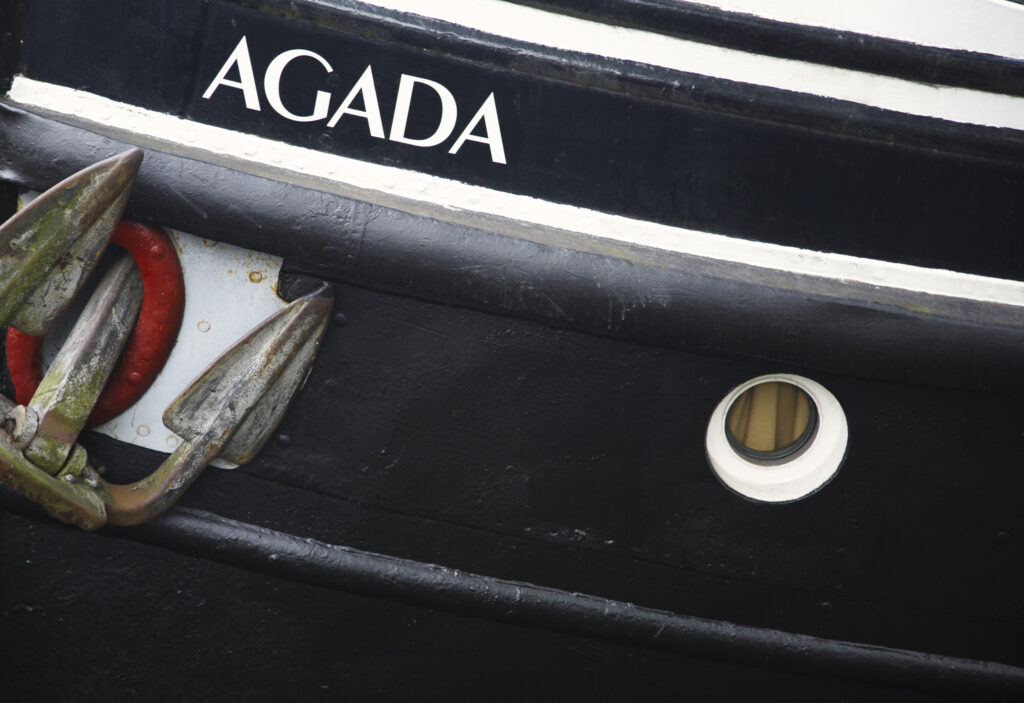 Netherlands, North Holland, Amsterdam. Boat moored on a canal in Amsterdam City.