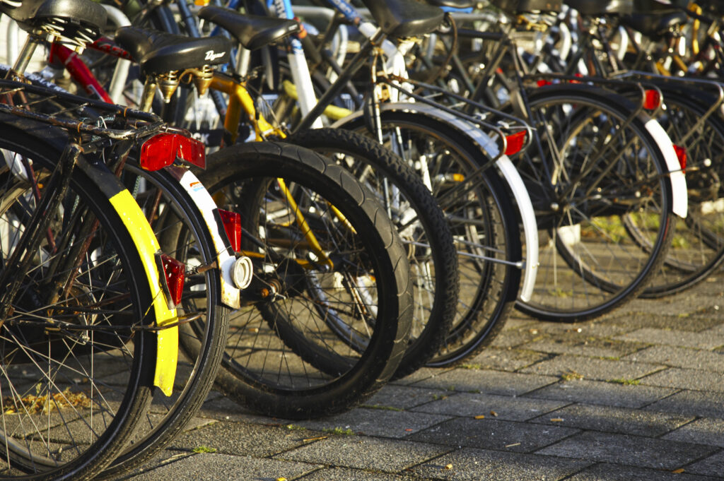 Netherlands, North Holland, Amsterdam. Bicycles left in bike racks along Kromme Waal in Amsterdam City.