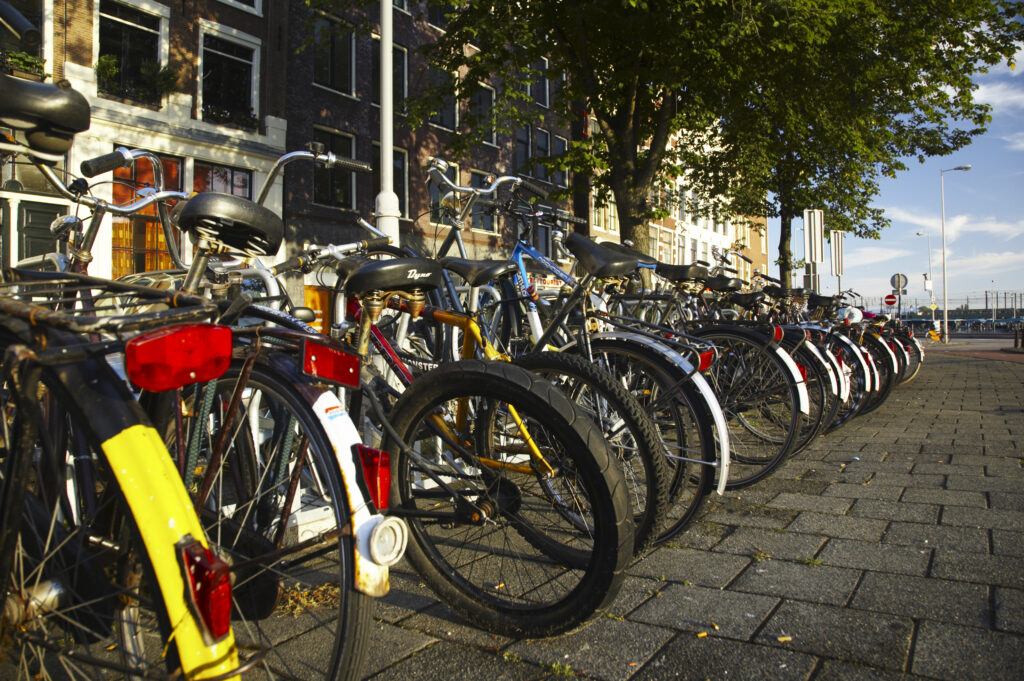 Netherlands, North Holland, Amsterdam. Bicycles left in bike racks along Kromme Waal in Amsterdam City.