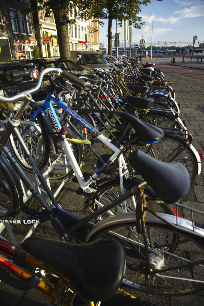 Netherlands, North Holland, Amsterdam. Bicycles left in bike racks along Kromme Waal in Amsterdam City.