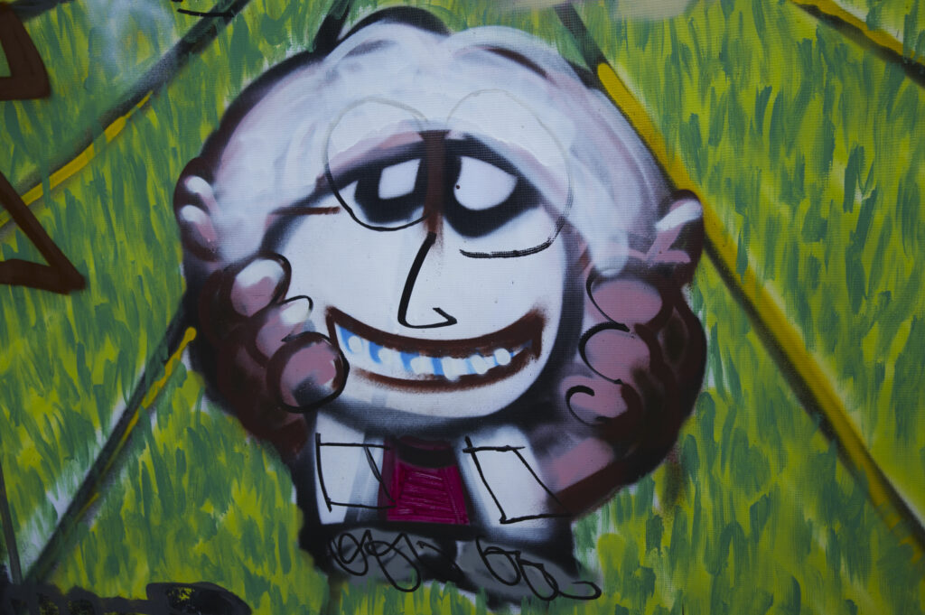 Netherlands, North Holland, Amsterdam. Graffiti sprayed / painted on a temporary fence panel in Amsterdam City.