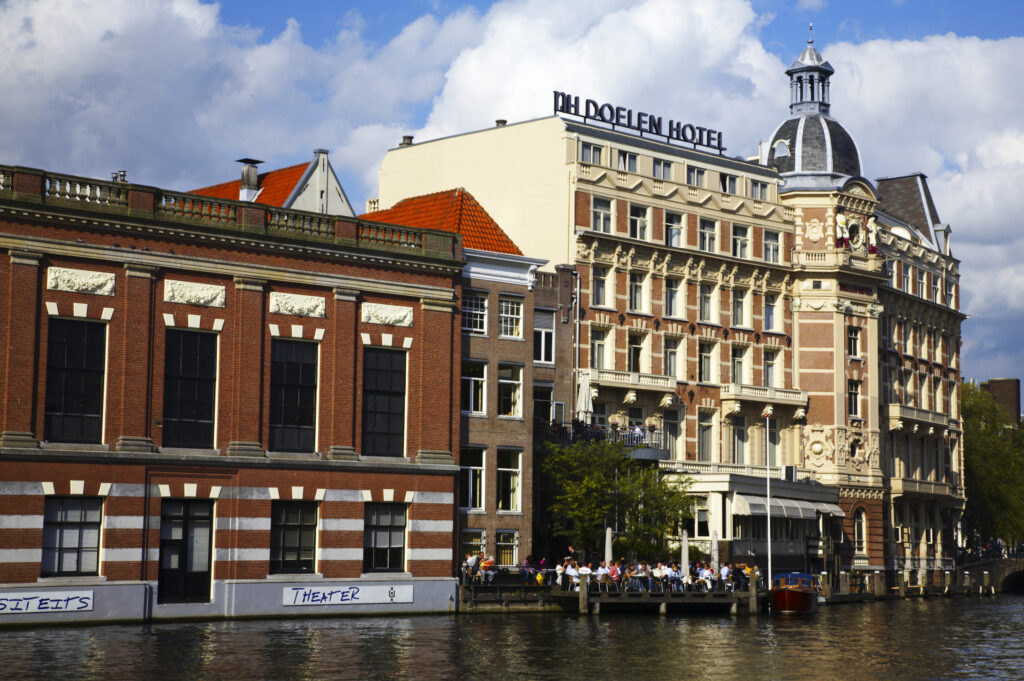 Netherlands, North Holland, Amsterdam. The oldest Hotel in Amsterdam, The NH Doelen Hotel, located on the banks of the River Amstel in Amsterdam City.