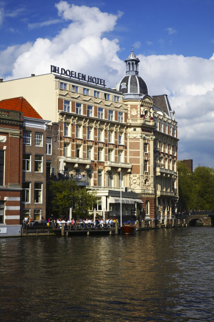 Netherlands, North Holland, Amsterdam. The oldest Hotel in Amsterdam, The NH Doelen Hotel, located on the banks of the River Amstel in Amsterdam City.