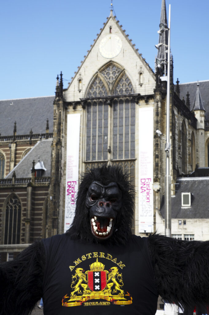 Netherlands, North Holland, Amsterdam. Street performer dressed as a Gorilla, outside Nieuwe Kerk (New Church) near the Royal Palace and Dam square in Amsterdam City.