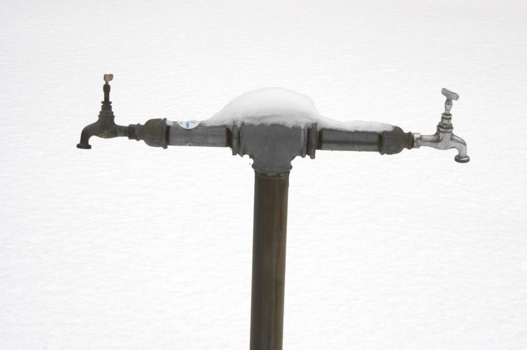 Norway, Oslo, Oslo City. Frozen water tap in the grounds of Bogstad camping in Oslo Forest near to Oslo city.