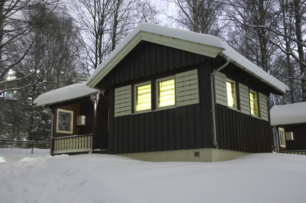Norway, Oslo, Oslo City. Snow covered wooden camping hut / cabin in the Bogstad camping ground in Oslo city.