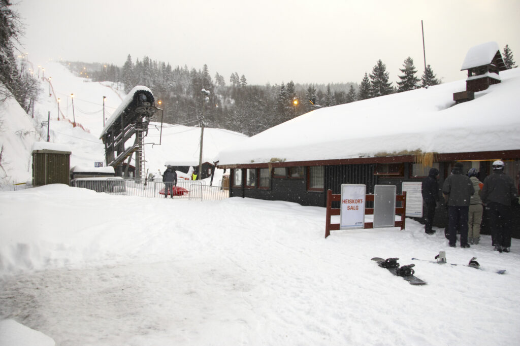 Norway, Oslo, Oslo City. Wooden buildings and ski tow bars at Wyller in the Tryvann Ski field, after a snowfall in Oslo Forest.