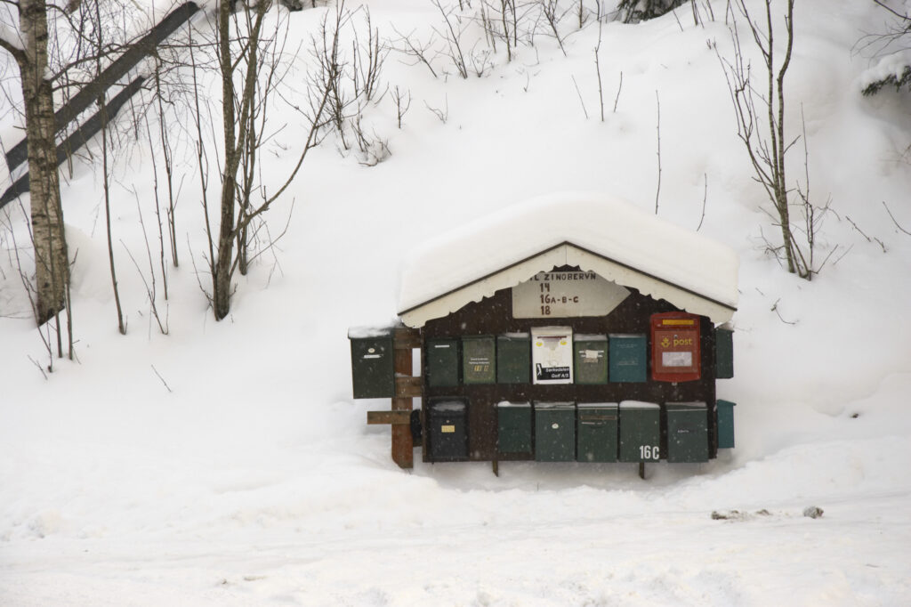 Norway, Oslo, Oslo City. Snow covered post box after a heavy snowfall near the Tryvann Ski field in Oslo Forest.
