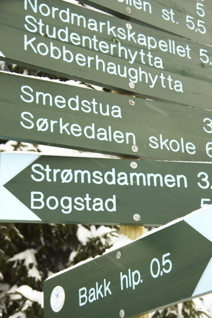 Norway, Oslo, Oslo City. Snow covered public footpath sign after a heavy snowfall near the Tryvann Ski field in Oslo Forest.