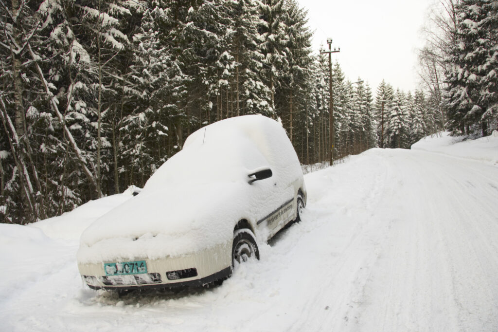 Norway, Oslo, Oslo City. A van abandoned after a heavy snowfall near the Tryvann Ski field in the Oslo forest.