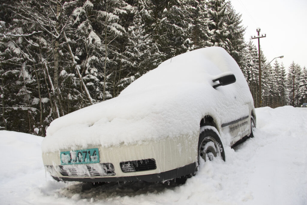Norway, Oslo, Oslo City. A van abandoned after a heavy snowfall near the Tryvann Ski field in the Oslo forest.