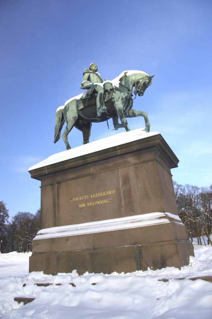Norway, Oslo, Oslo City. Statue of King Karl Johan in the grounds of the Royal Palace, after a heavy winter snow fall.