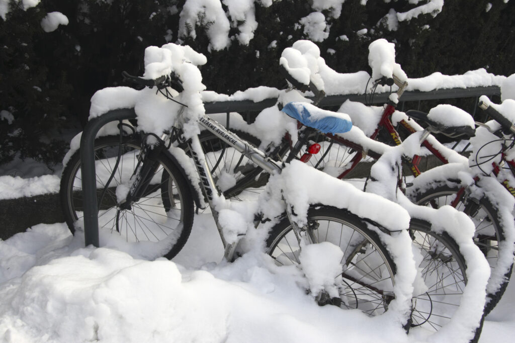Norway, Oslo, Oslo City. A collection of bicycles covered in snow and ice after being abandoned after a heavy snowfall.