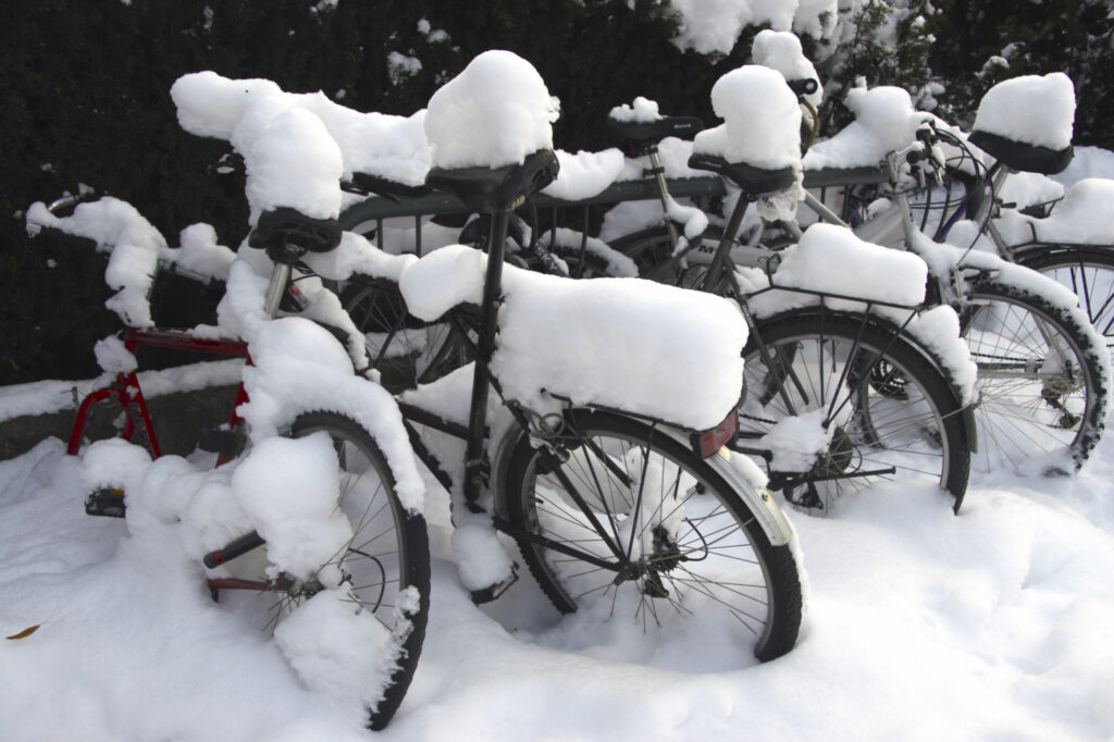 Norway, Oslo, Oslo City. A collection of bicycles covered in snow and ice after being abandoned after a heavy snowfall.