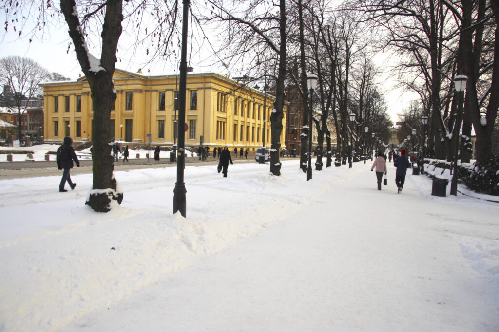 Norway, Oslo, Oslo City. The snow covered Karl Johans street and the impressive architecture of the University Of Oslo Building