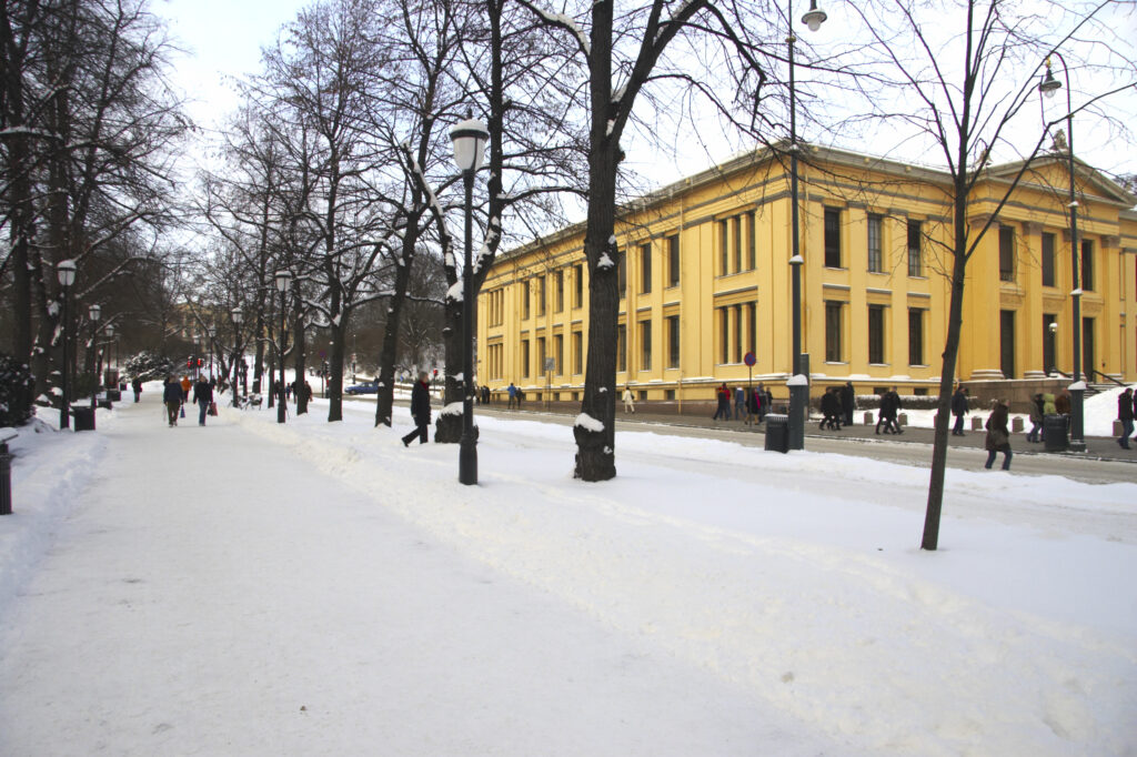 Norway, Oslo, Oslo City. The snow covered Karl Johans street and the impressive architecture of the University Of Oslo Building