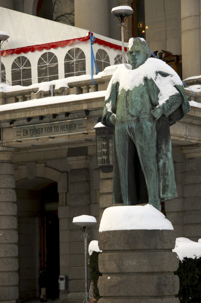 Norway, Oslo, Oslo City. Snow covered statue outside the National Theatre, in the city of Oslo.