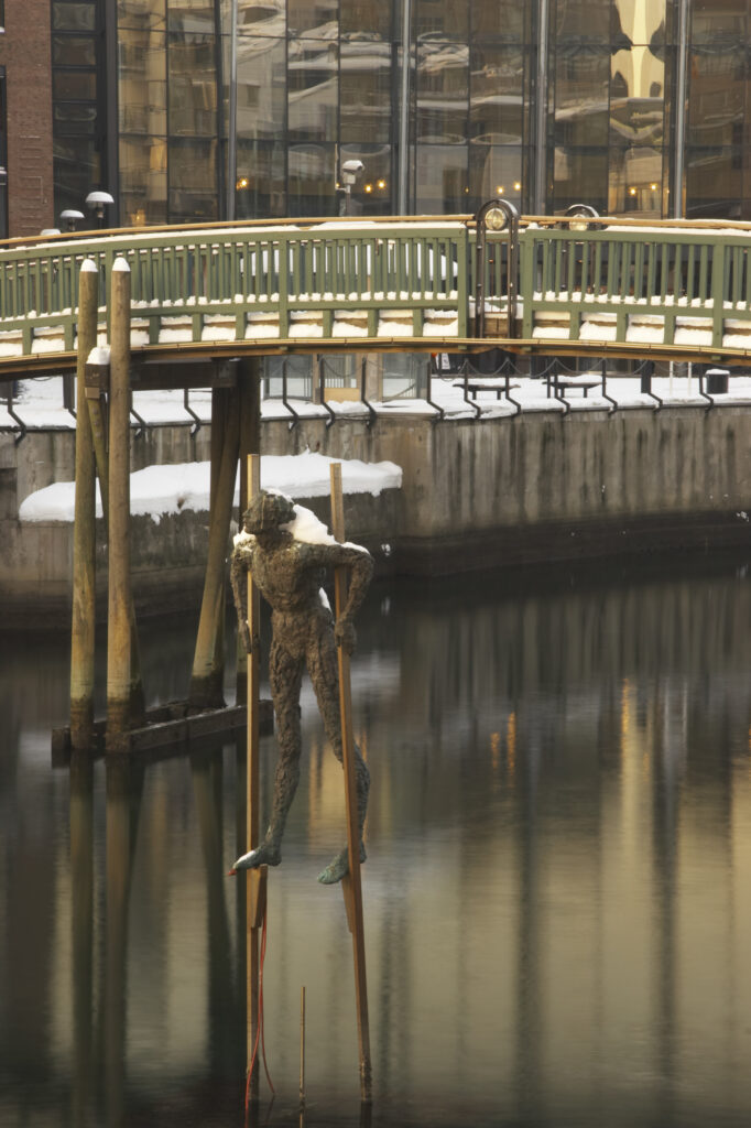 Norway, Oslo, Oslo City. A winter scene of a bridge and a statue in a canal near Aker Quay, in Oslo city.