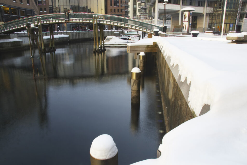 Norway, Oslo, Oslo City. A winter scene of a bridge over a canal near Aker Quay, in Oslo city.