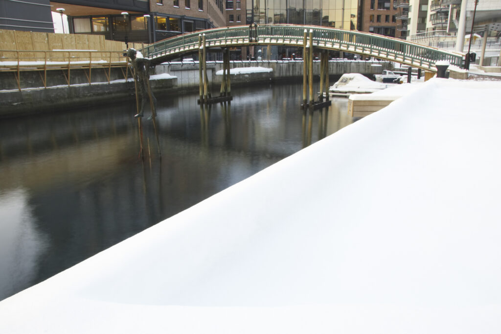 Norway, Oslo, Oslo City. A winter scene of a bridge over a canal near Aker Quay, in Oslo city.