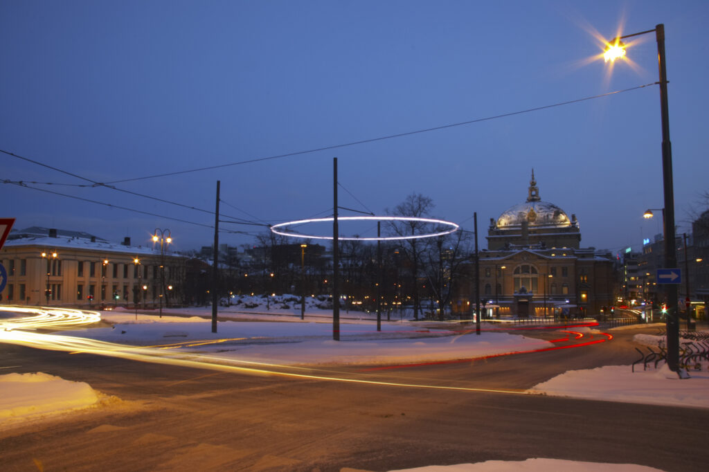 Norway, Oslo, Oslo City. Traffic trails running through a cityscape scene near the National Theatre in Oslo City / Oslo region.