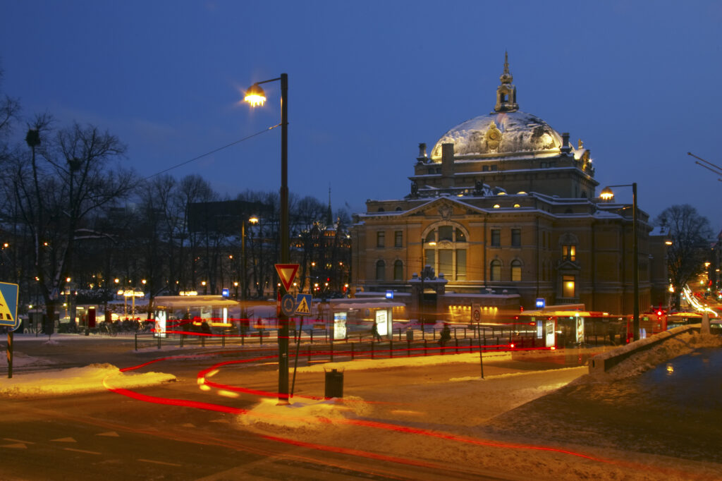 Norway, Oslo, Oslo City. Traffic trails running through a cityscape scene near the National Theatre in Oslo City / Oslo region.