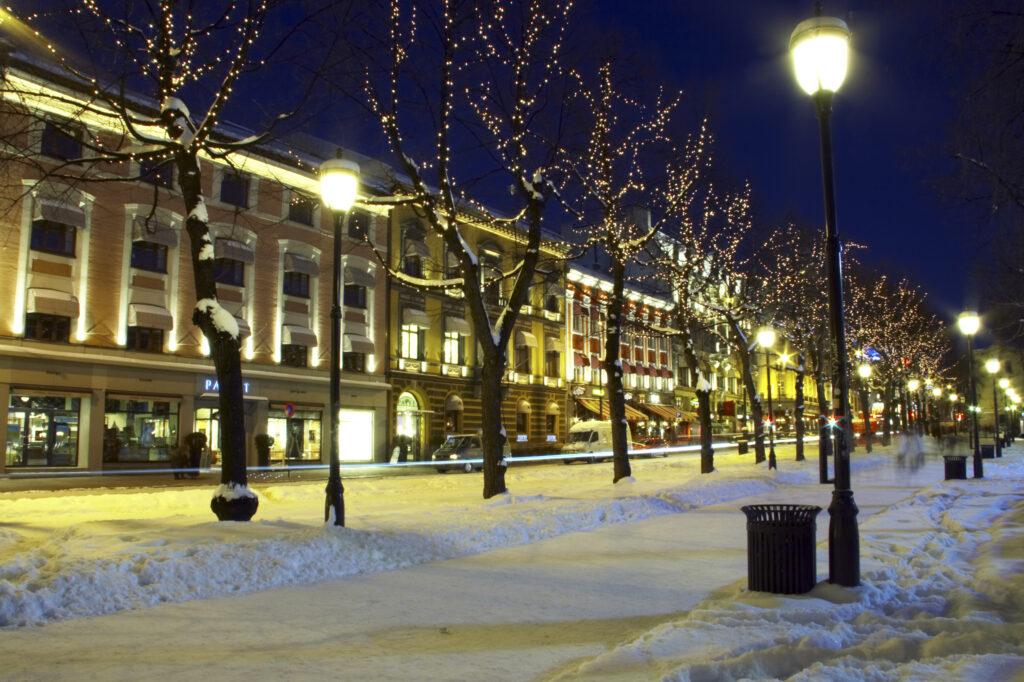Norway, Oslo, Oslo City. Street lights illiminate a cityscape scene near the National Theatre in Oslo City, in the Oslo region