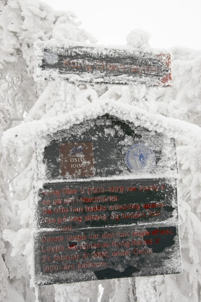 Norway, Oslo, Holmenkollen. A snow covered route direction sign found in the Holmenkollen area near to the Tryvann Ski-field.