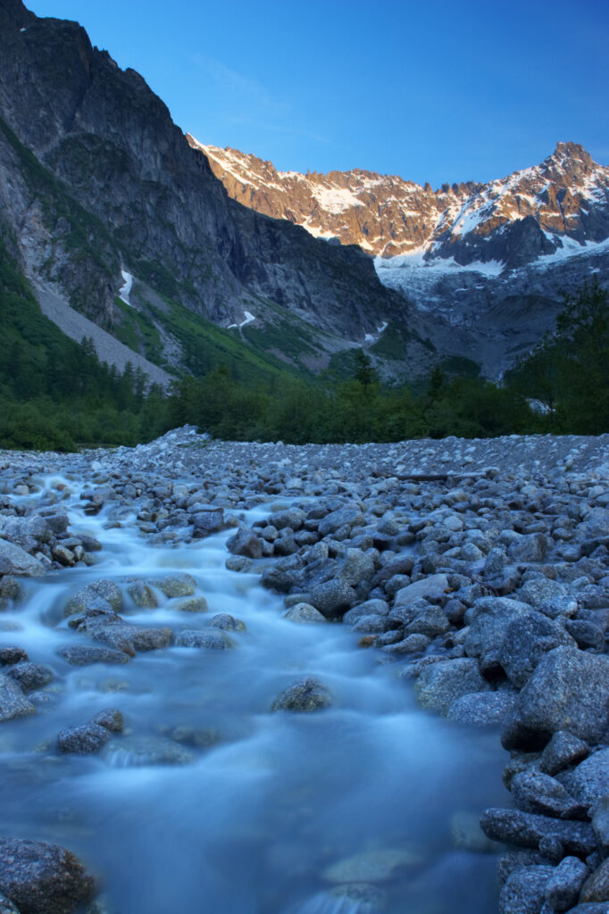 Switzerland Valais Val Ferret. A stream running through a dramatic mountain landscape near the village of La Fouly