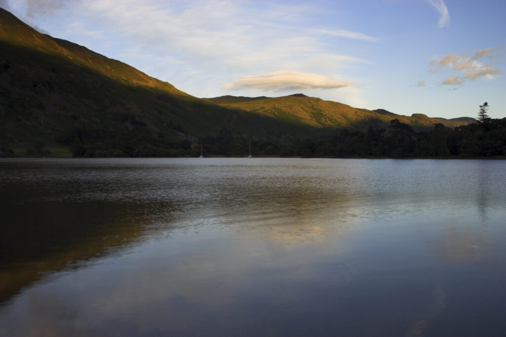 England Cumbria Ullswater The surrounding hills reflected in the waters of Ullswater, part of the Lake District National Park.