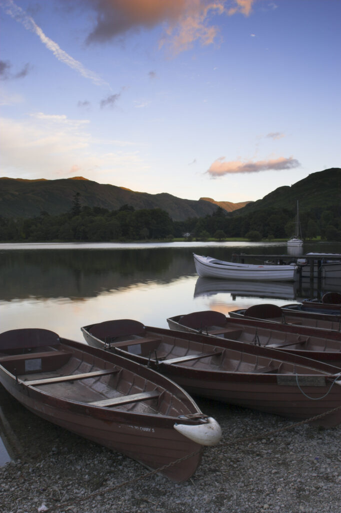 England Cumbria Ullswater Rowing boats and the sweeping vista of Ullswater part of the Lake District National Park