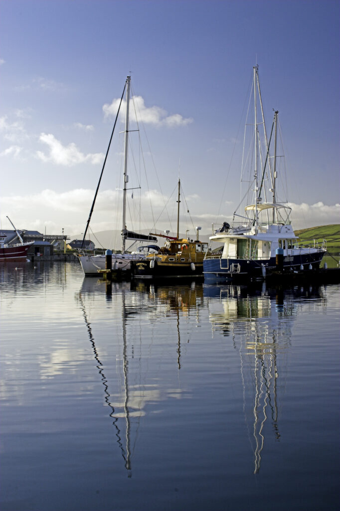 Ireland County Kerry Dingle Peninsula Boats reflected in the still waters of the Dingle Harbour in Dingle Bay