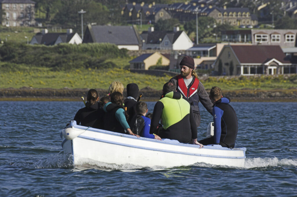 Ireland County Kerry Dingle Peninsula A group of snorklers on a small boat looking over Dingle Bay search for Fungi the dolphin