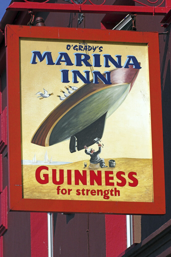 Ireland County Kerry Dingle A colourful guinness stout sign on a pub in the town of Dingle