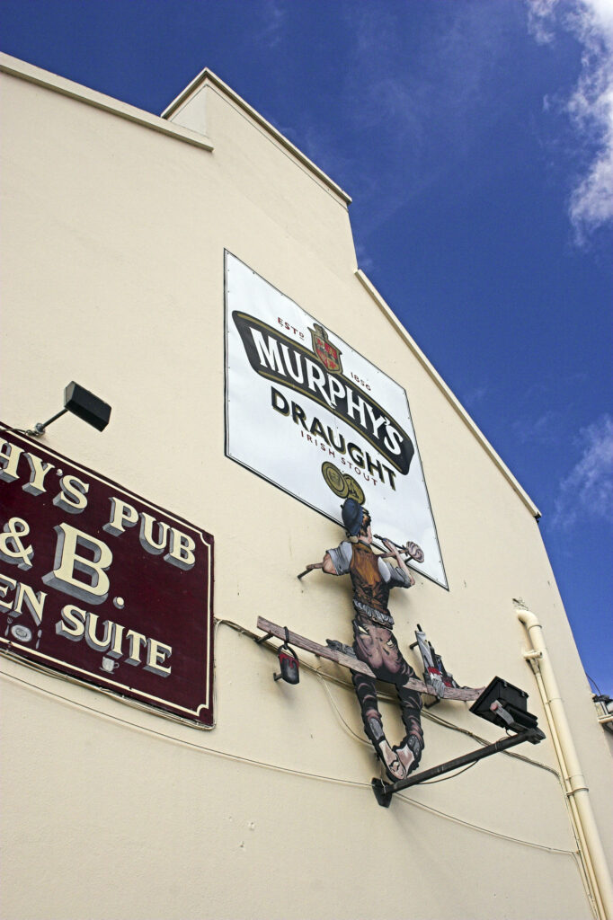 Ireland County Kerry Dingle A large sign advertising Murphys stout on the side of a pub in Dingle