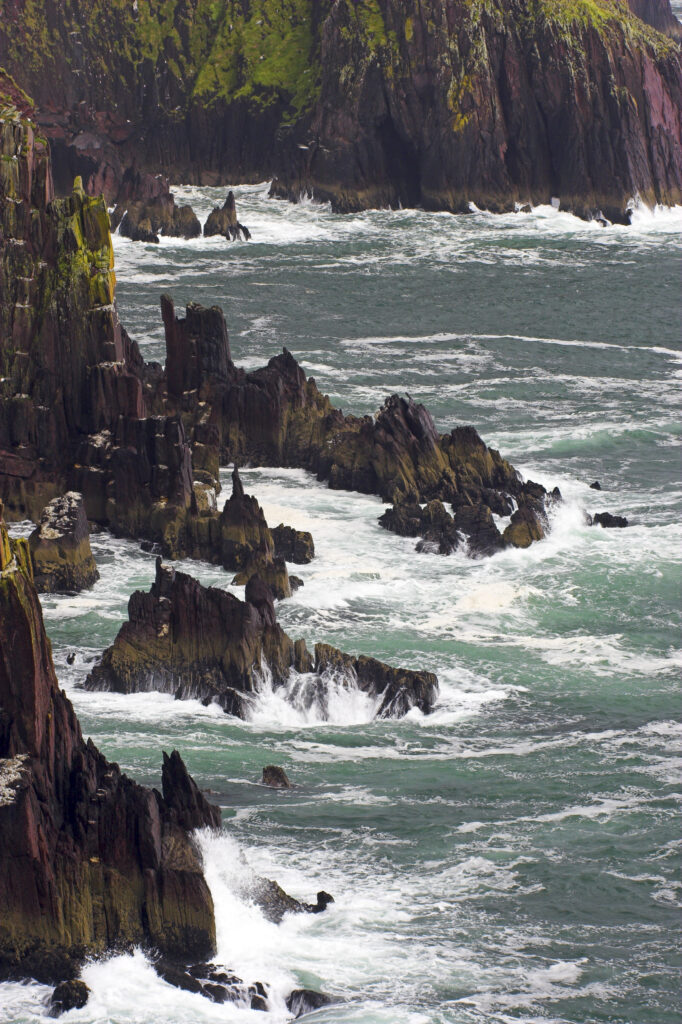 Ireland County Kerry Dingle Peninsula Waves crash against the sheer cliffs of Dingle Bay in the Dingle Peninsula