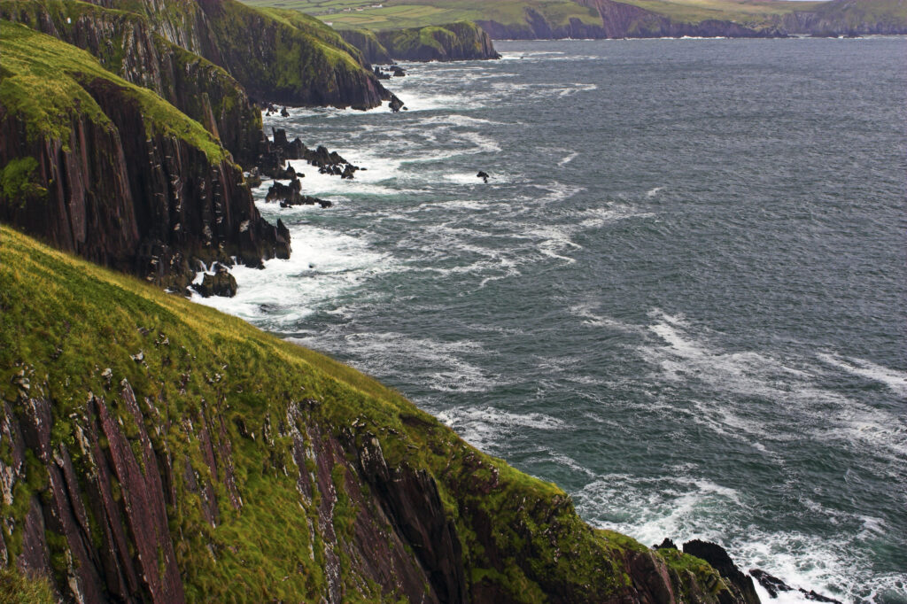 Ireland County Kerry Dingle Peninsula Waves crash against the sheer cliffs of Dingle Bay in the Dingle Peninsula