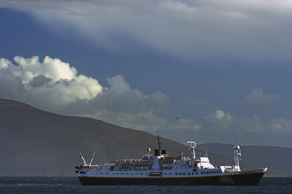 Ireland County Kerry Dingle National Geographic boat / cruiser anchored near Dingle Bay on the Dingle Peninsula