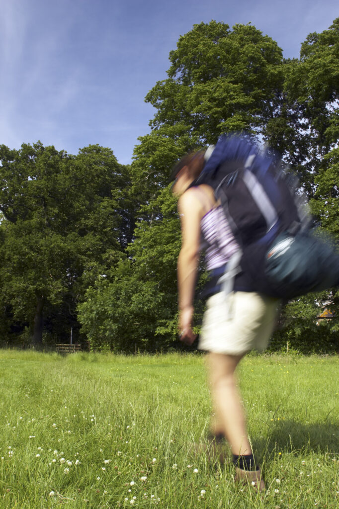 England, Cumbria, Female hiker along the Cumbria Way track.A girl walker, heading from Rose Bridge towards Lime House School