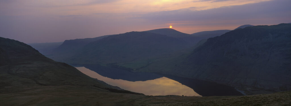ENGLAND Cumbria Lake District National Park Sunset reflected in the still waters of Wast Water Englands deepest lake.