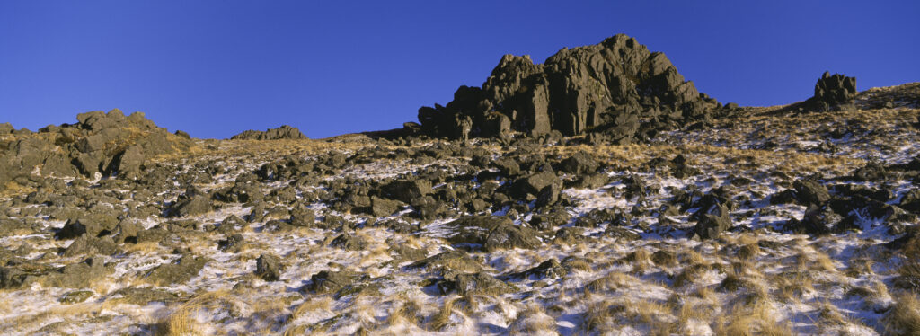ENGLAND Northumberland Northumberland National Park A rocky outcrop found high above Harthope Valley surrounded by snow.