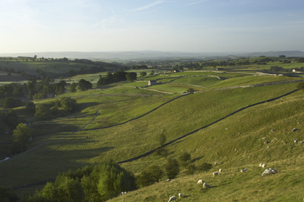 England, Yorkshire, Yorkshire Dales National Park. View captured from near the impressive natural rock formations / geology of limestone paving above Malham Cove in the Yorkshire Dales National Park