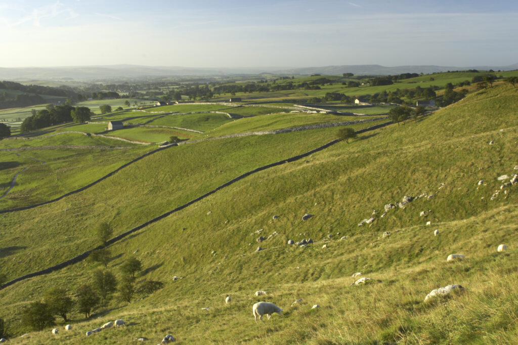 England, Yorkshire, Yorkshire Dales National Park. View captured from near the impressive natural rock formations / geology of limestone paving above Malham Cove in the Yorkshire Dales National Park