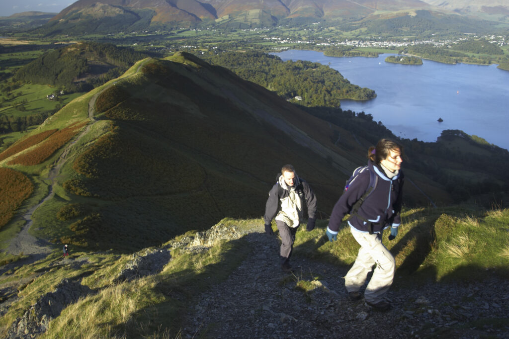 ENGLAND Cumbria Lake District National Park Hikers walking up Cats Bells near Derwentwater.
