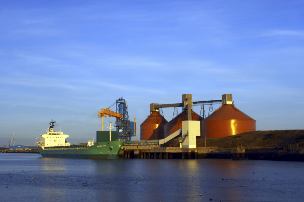 England, Northumberland, Blyth. Storage silos and tanker at Blyth harbour.